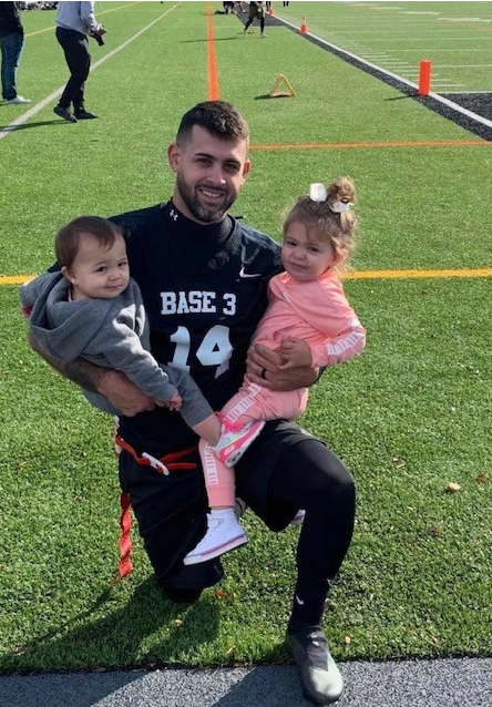 DJ Romano posing with family.