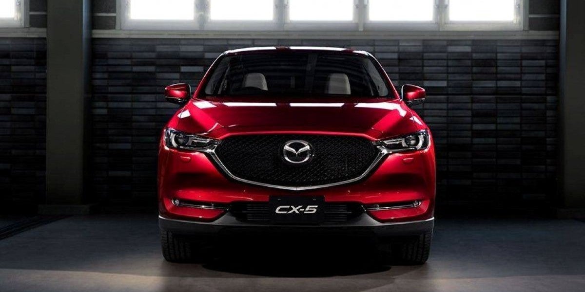 Front view of a red Mazda CX-5 SUV parked indoors under natural light.